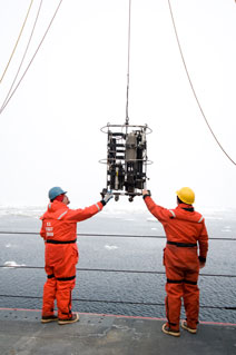 Figure 7: Lowering instruments to collect water samples in the open ocean.
