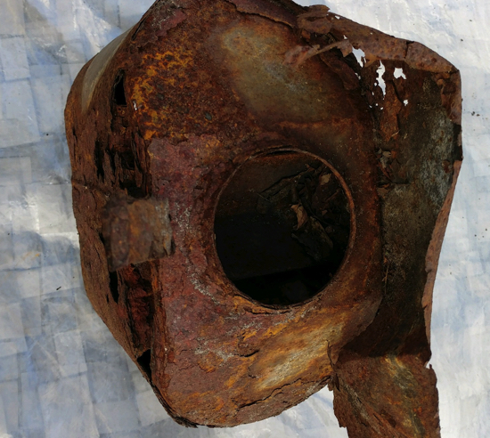 Plenty of the iron in this muffler combined with oxygen in the environment, creating rust and leaving holes in the muffler where the iron has been consumed.