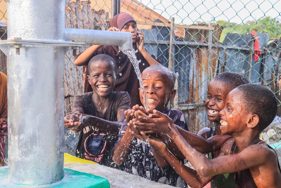 Figure 1: Boys drink water from rehabilitated wells by AMISOM in EL-Ma’an, Bal’ad District of HirShabelle State, Somalia.