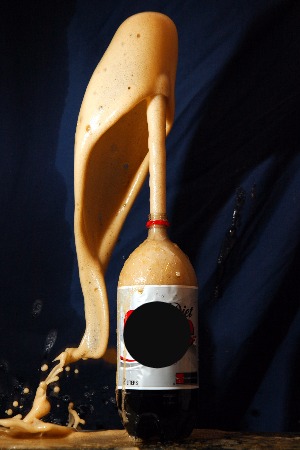 Figure 3: The bubbles that form in a bottle of soda are CO2 ^~molecules in gaseous form. Here, the CO2 is rapidly converted to a gaseous form when a certain candy is added, resulting in a dramatic reaction.